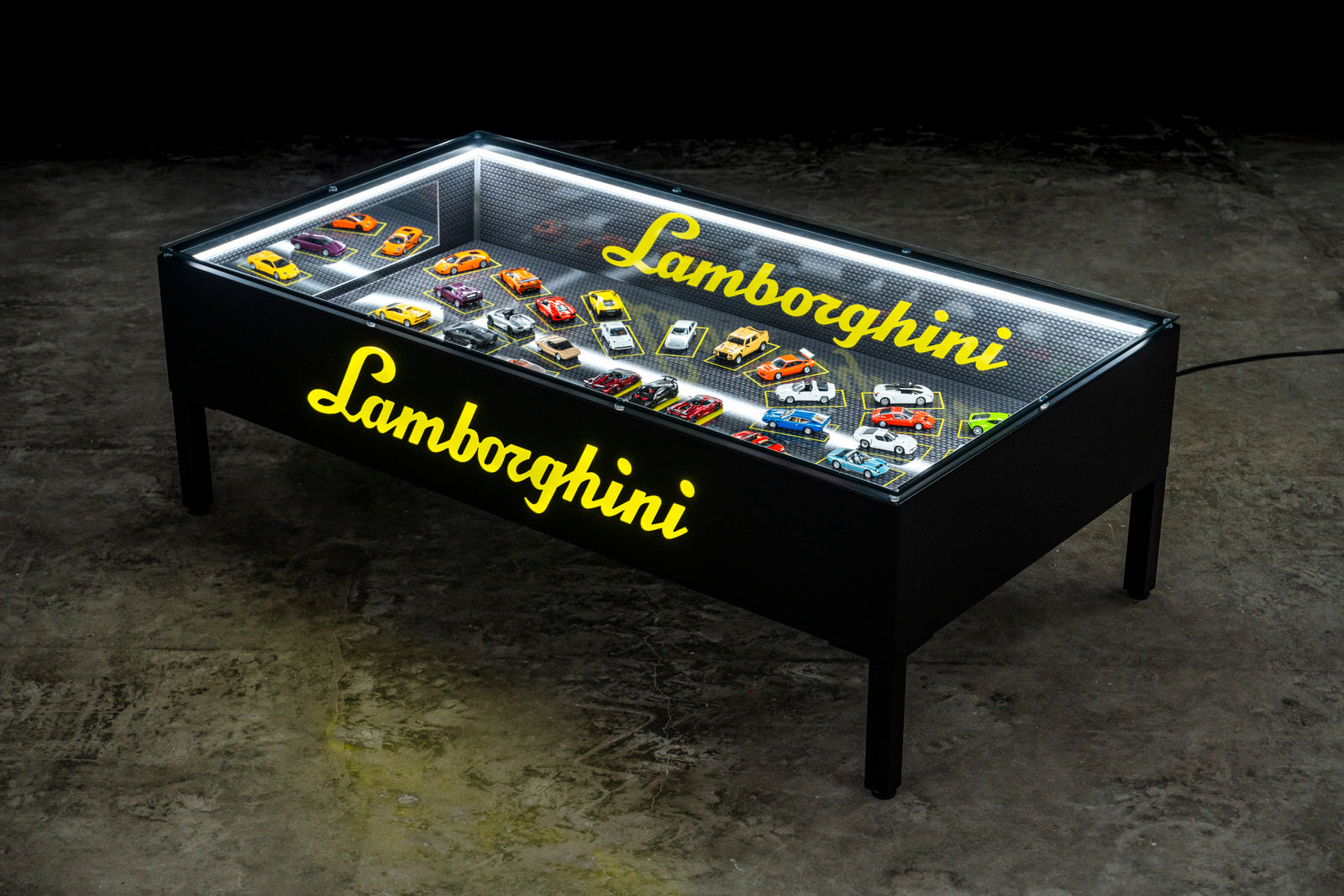 Lamborghini scale models arranged under glass. / Modellini Lamborghini disposti sotto vetro